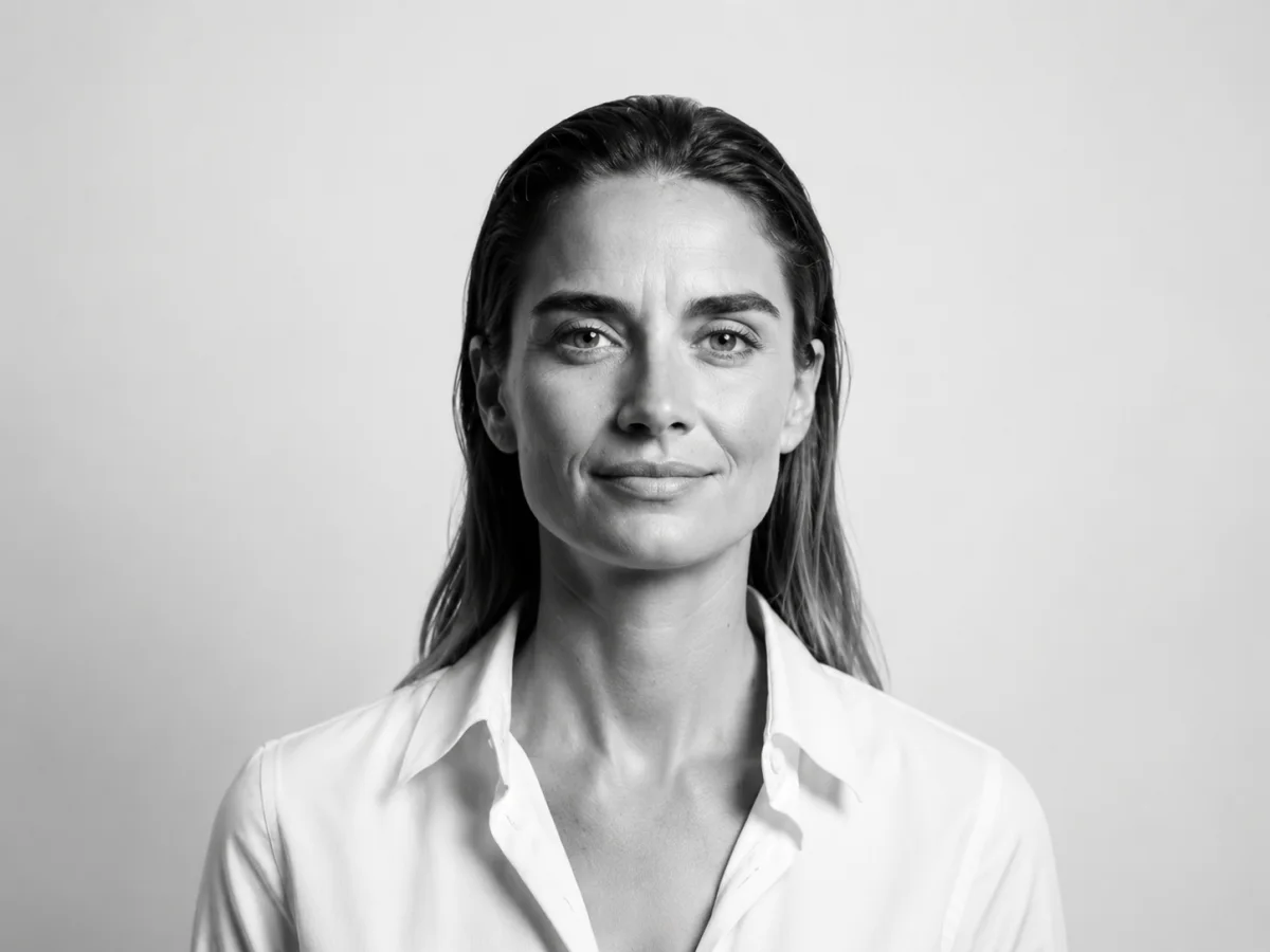 Black-and-white portrait of M. Agius, the author — a woman in a white shirt against a plain light background